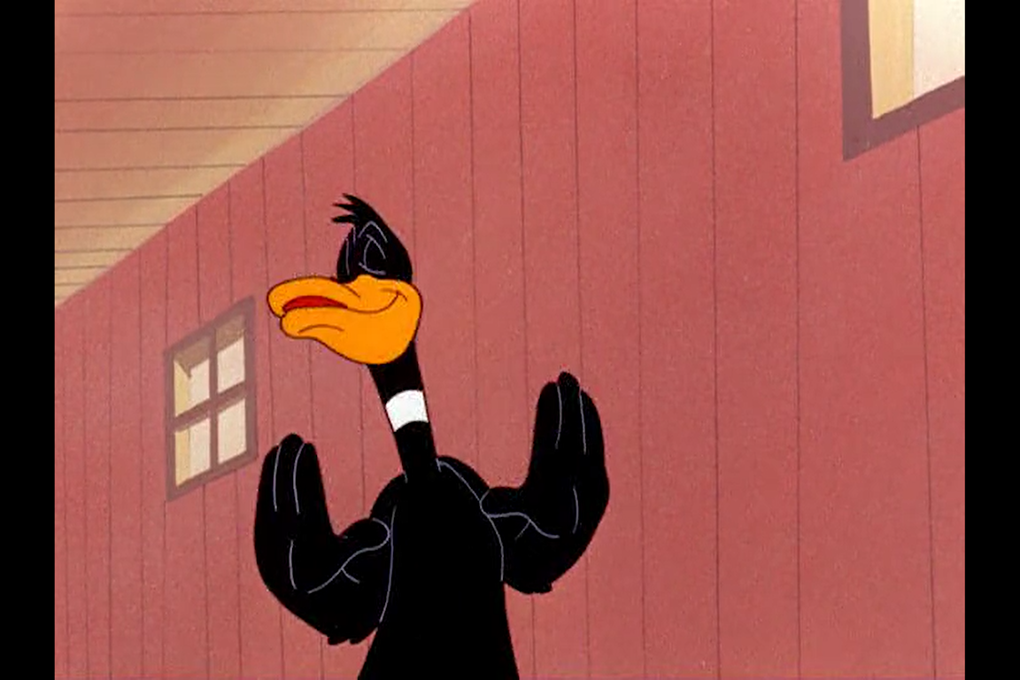 Daffy Duck holds up his hands.
